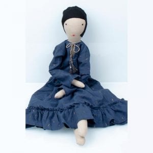 Eco friendly doll Calla 2 comes dressed in traditional blue skirt and white blouse, made from off cuts of Indian cotton from the fabric industry.