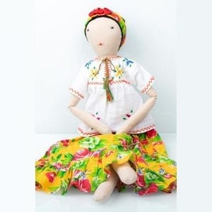 Frida doll in colourful, yellow patterned skirt and white blouse. Eco-friendly, supporting sustainable incomes for communities of refugees in India.