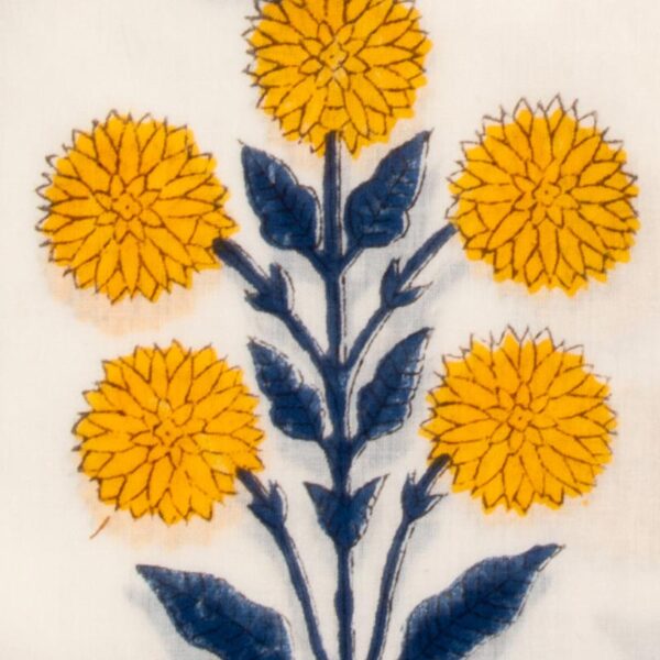 Close up detail of marigolds on White sarong with yellow marigold blooms and intricate blue patterns, bordered by a mustard yellow design.
