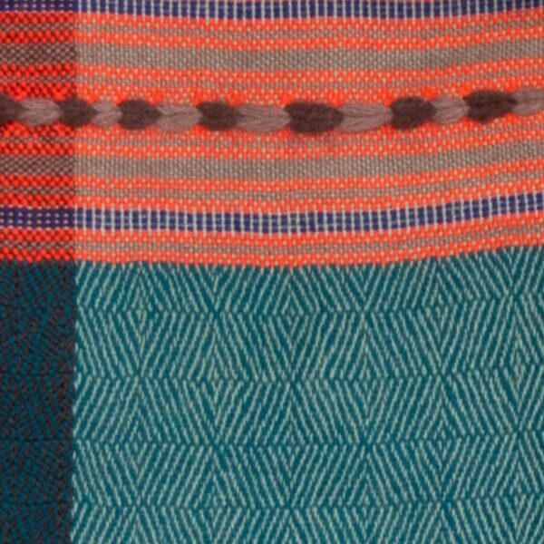 Detail of Handwoven cashmere wool scarf with vibrant stripes and patterns, named 'Winter Solstice'.